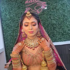 A detailed shot of the bridal makeup, focusing on the soft cut-crease eyeshadow with a hint of shimmer and a flattering pink lip tone. The makeup is set to be long-lasting and picture-perfect.