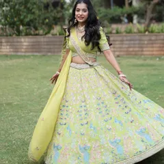 A client twirling in a lime green lehenga with delicate peacock embroidery. This is a fresh and vibrant look for any pre-wedding celebration.