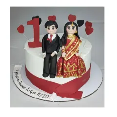 One year down, forever to go! This first-anniversary cake is a chocolate truffle delight, topped with custom handmade fondant figures of the couple in their wedding attire.