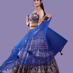 A dynamic studio shot capturing the movement of the model's blue dupatta. This type of action shot adds energy and variety to a model's portfolio.