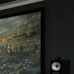 Experience audio excellence with Bowers & Wilkins. This close-up shows a B&W tower speaker next to a projection screen, delivering precise and powerful sound for an immersive sci-fi movie experience.