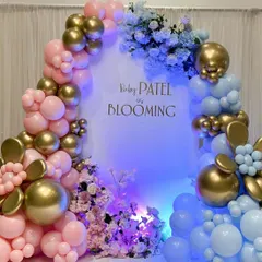 The stunning pink and blue balloon arch under dramatic lighting, creating the perfect photo opportunity for a gender reveal party.