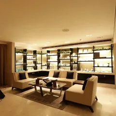 Our client lounge is a space of comfort and elegance, featuring beautifully backlit shelves displaying our premium product lines. It's the perfect place to consult with our experts or relax before your service begins.