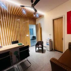 The main reception and office area. I used a combination of a custom wood slat feature wall, integrated lighting, and clean lines to create a space that feels both professional for staff and inviting for parents.