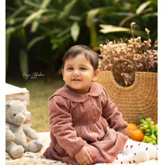 There's something special about an outdoor session, especially for a first birthday. We set up a cozy picnic with a teddy bear, fresh fruits, and soft blankets to create a dreamy, natural setting for this little one's milestone portraits in a Gurugram park.