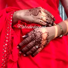 The rich, dark color of the henna stain against a vibrant red saree. This shows how beautifully our natural henna develops, perfect for your wedding day look.