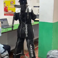 A shooter in full competition gear, demonstrating the focus and form required for 10m air rifle events.