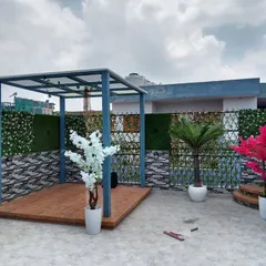 A terrace makeover I completed in Paschim Vihar, Delhi. This features a custom-built pergola with a raised wooden deck, artificial green walls, and decorative trees.