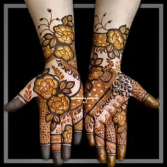 This rose-themed mehendi is a popular choice for siders. The design combines shaded roses with intricate dot-work and leafy trails that extend up the arm.