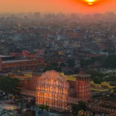 The golden hour light bathes Hawa Mahal in Jaipur, as seen from my drone. The sunset paints the sky in fiery colors, matching the iconic pink of the palace.