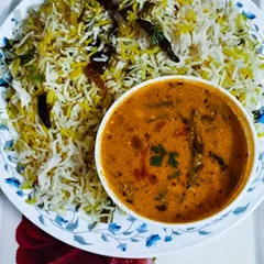 A simple and elegant meal of Bagara Rice served with a mixed vegetable kurma. The fragrant rice is made with whole spices and basmati rice, a Hyderabadi specialty.