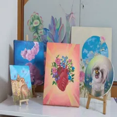 A collection of some of my recent canvas paintings displayed in my studio. This shows the variety of my smaller works, including a custom pet portrait, the floral heart, and other nature-inspired pieces, all done in my signature colorful style.