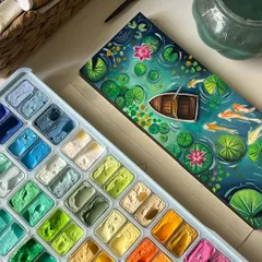 The finished koi pond painting next to my gouache palette, showing the beautiful range of greens and blues I used.