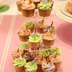 A close-up of the unicorn cupcakes from the "Wonderland" party. Each one is topped with pastel frosting and a tiny, handcrafted unicorn horn and ears, ensuring every single bite fits the magical theme.