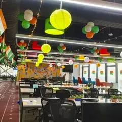 This modern office space was decorated for a national holiday with hanging paper lanterns and balloon clusters. The decor is festive but not intrusive, maintaining a productive work environment.