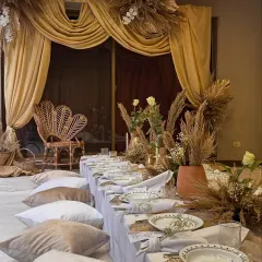 This intimate dinner was designed with an "Arabic Night" theme, featuring low floor seating on plush cushions and a warm, earthy color palette. The goal was to create a cozy and luxurious atmosphere for a pre-wedding celebration.