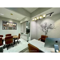 Our studio's conference area and principal architect's cabin. The space features a custom wall mural, modern lighting, and comfortable leather chairs, designed to foster creativity and collaboration.