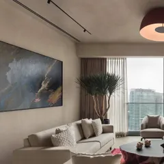 In the East Coast Residence, we used a palette of soft, earthy tones and rich textures to create a warm and inviting atmosphere. A large abstract painting adds a splash of color and personality to the minimalist living room design.