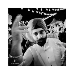 A cool, candid shot of the groom on the dance floor, captured with a touch of motion blur to convey the energy of the party.