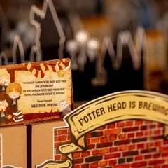 A close-up of the handcrafted details on my Harry Potter hampers, including a personalized thank you card with wizarding world puns.