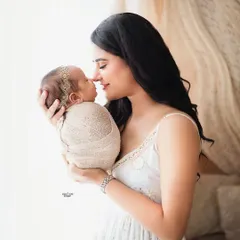 Those first few days are so precious. This tender moment between a mother and her newborn is captured in a soft, natural light to highlight that incredible bond. I focus on creating a calm space for these delicate newborn and parent portraits.