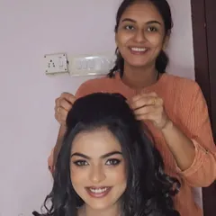 A behind-the-scenes moment of me creating a classic Christian wedding look. The bride is all smiles, happy with her voluminous curls and soft makeup.