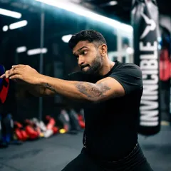 Developing core stability and rotational power with plate exercises. This kind of functional core training is essential for striking and grappling.