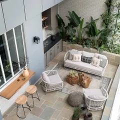 In a city like Mumbai, an outdoor space is a true luxury. This aerial view shows how I transformed a 500 sq. ft. deck into a sprawling urban oasis, complete with a mobile bar, lush planters, and comfortable seating, making it the heart of the home for social gatherings.