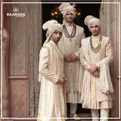 Three grooms stand together, each in a unique sherwani from the Shauhar collection. The image highlights variations in embroidery, draping, and accessories, showing how each piece is tailored to a personal style while maintaining a cohesive royal aesthetic.