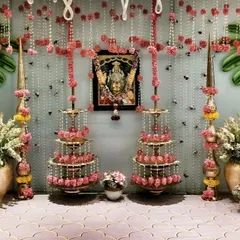 Creating a divine atmosphere at home for a pooja ceremony is all about the details. This bridal pooja setup combines traditional brass lamps, beautiful flower arrangements, and a pearl curtain backdrop to create a peaceful and sacred setting for rituals.