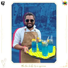 Our mixologist serving a tray of vibrant blue mocktails. Our non-alcoholic creations are colorful, fun, and perfect for daytime events.