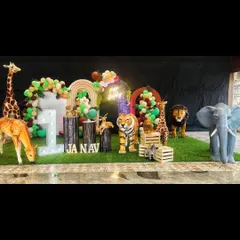 For a truly immersive safari experience, we use large, realistic animal props like this giraffe, elephant, and tiger. Paired with a balloon arch and light-up 'ONE' sign, it creates a spectacular wild animal theme for a first birthday.