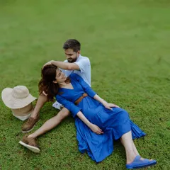A playful and relaxed moment captured in the open fields near Bangalore. This image showcases a casual and fun pre-wedding session, where the couple's joy is the main focus against a serene, natural backdrop.