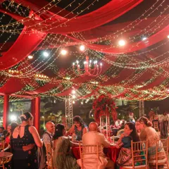 We believe a reception should feel like a galaxy of joy. For this night, we draped the sky in rich red fabric and a constellation of fairy lights, creating a warm, vibrant space where guests could share laughter and make memories under the stars.