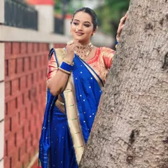 Another angle of the traditional Maharashtrian look, showcasing the elegant hairstyle and how the makeup complements the royal blue saree.