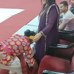 A moment of respect and tradition, as a young performer seeks blessings before her dance. We instill values of grace and respect in our students alongside dance techniques.