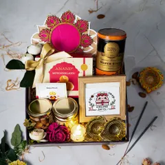 This premium Diwali hamper is designed for a lasting impression. It features motichoor ladoo, jars of fine nuts, wafer sticks, and our branded frame, along with fragrant incense and brass diyas, all nestled in a keepsake box.