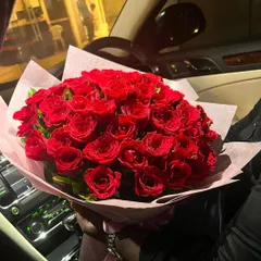 POV: He knows roses are your love language. This stunning, oversized bouquet of vibrant red roses is the ultimate romantic gesture, beautifully wrapped in soft pink paper.