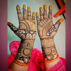 A beautiful floral mehandi design where flowers are the main theme, covering the palms and wrists in a garden-like pattern.