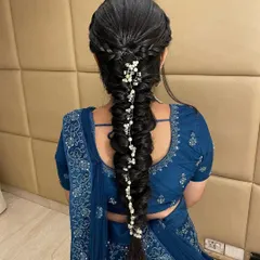 An intricate and modern fishtail braid, decorated with delicate pearl accessories. This hairstyle is perfect for a sangeet or reception lehenga.