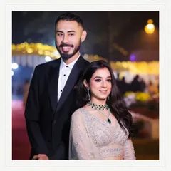 A formal portrait of the couple, smiling for the camera. This image is perfect for announcements, capturing their happiness and the celebratory feel of their engagement night.