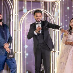 Sharing a laugh with the groom and bride on their Sangeet stage in Lonavala. My approach is all about creating genuine, unscripted moments of joy.