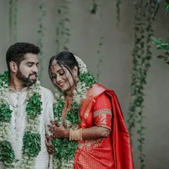 A lovely portrait of the couple against a wall of green vines, their smiles reflecting the joy of the day.