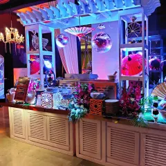 The Asian-themed station viewed under dramatic blue and purple lighting. We work with event lighting to ensure our setups look spectacular at any time of day.