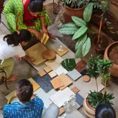 A closer look at our collaborative material selection. We believe in touching and feeling the textures, from woven cane and rough stone to smooth wood and living leaves, to make informed design decisions together.