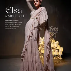 The Elsa Saree Set reimagines traditional elegance with its stunning ruffle design. This dynamic pose highlights the voluminous, tiered ruffles and the meticulously hand-adorned belt that cinches the waist.