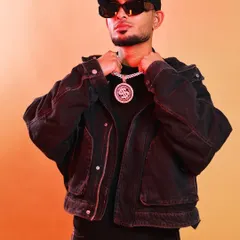 A confident pose during a photoshoot, adjusting my chain. My look is an important part of my brand as a hip hop artist and DJ.