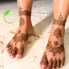 Beautiful feet mehendi featuring hanging jhumka designs. The pattern covers the top of the foot and includes detailed work on each toe.