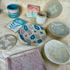 Another angle of the vibrant, finished student pieces. This image highlights the diverse styles, from floral patterns and marbled effects to intricate mandala designs.
