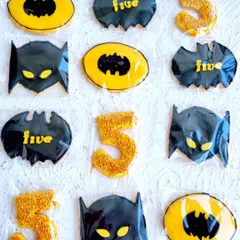 A collection of Batman-themed sugar cookies. I teach how to flood cookies with royal icing and add details to match any party theme.
